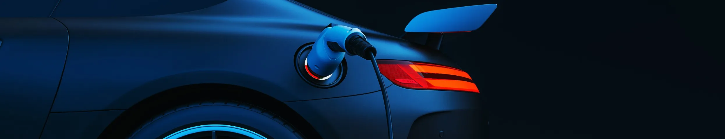 Electric vehicle charging at night, blue charging cable connected to a dark sports car